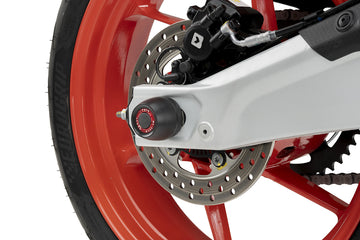 Puig 22238N Swing Arm Protector for Aprilia RS 457 2024-26, black machined nylon rear axle slider with optional coloured anodised aluminium rings