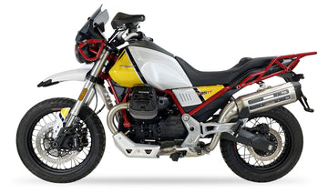 IXIL Mega Xtrem Trail dual-exit stainless steel slip-on silencer for Moto Guzzi V85 TT 2018-22, satin-polished hexoval exhaust with asymmetric black conical end cap, removable upper dB killer and side pannier compatibility